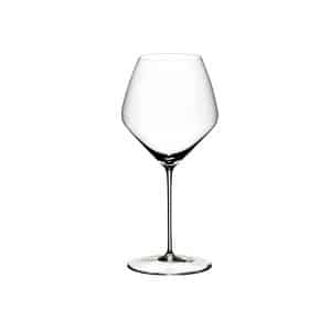 Two Riedel Veloce Pinot Noir / Nebbiolo glasses filled with red wine on a tasting table – available at The Wine Box.