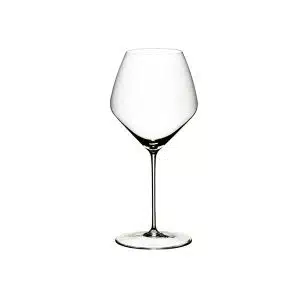 Two Riedel Veloce Pinot Noir / Nebbiolo glasses filled with red wine on a tasting table – available at The Wine Box.