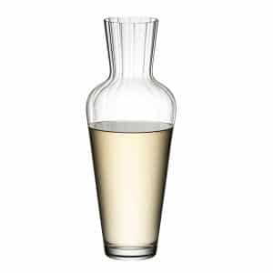 Crystal-clear Riedel Wine Friendly Decanter on a wooden table, filled with red wine – available at The Wine Box.